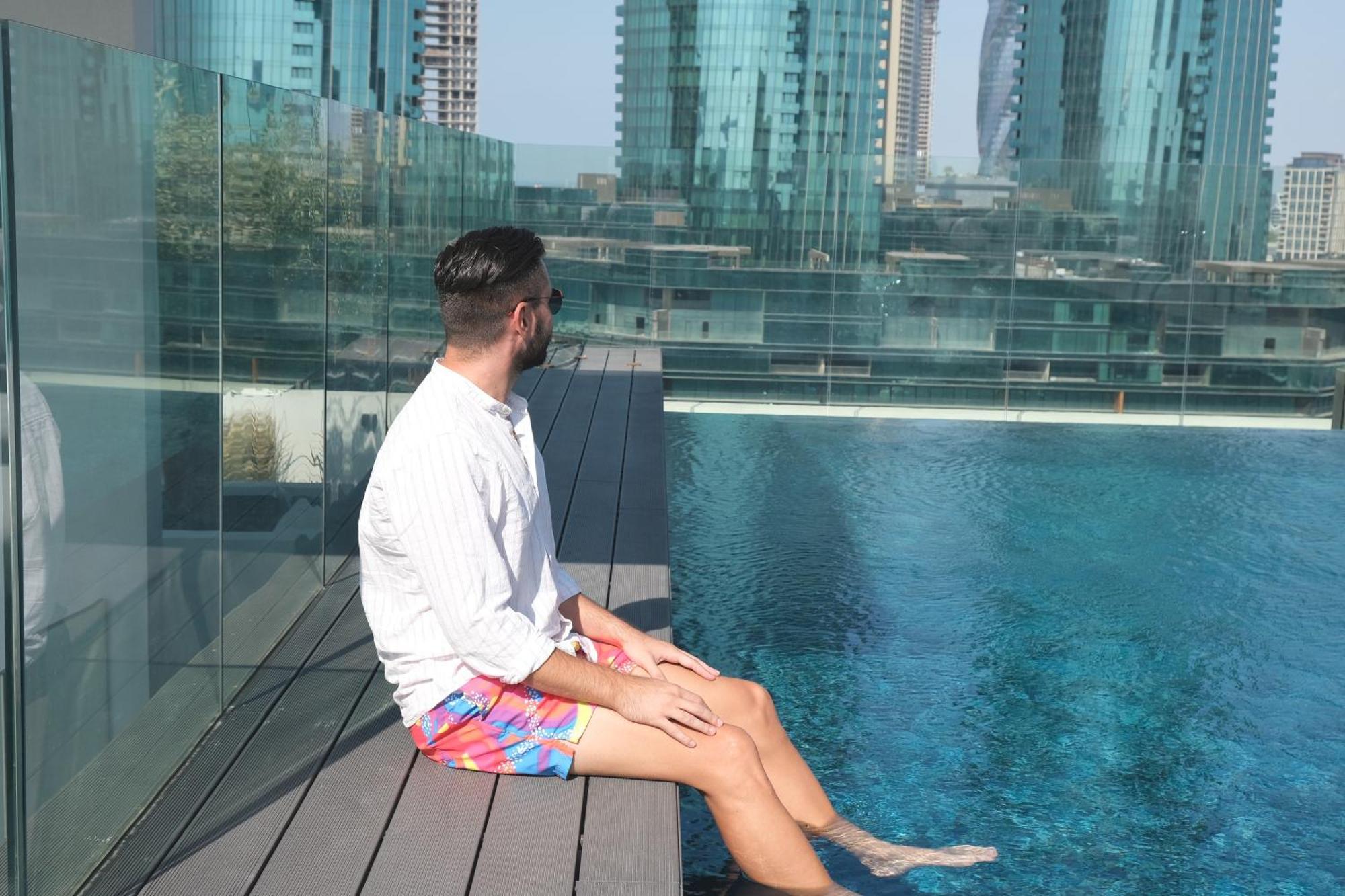 Charthouse Bahrain Hotel Manama Luaran gambar A man sitting on the edge of a pool